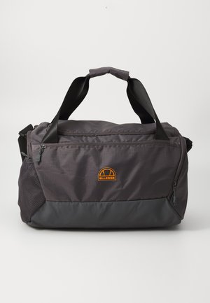 Duffle bag in dark gray fabric with a smooth texture, featuring a contrasting black bottom, top handles, and an orange logo on the front.