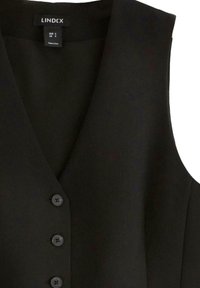 Top senza maniche nero con un design a V, caratterizzato da cinque bottoni e una texture di tessuto liscia. Etichetta visibile all'interno.