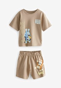 Tan, cotton two-piece outfit featuring a short-sleeve t-shirt with a graphic of a blue cartoon dog and shorts with a similar design.
