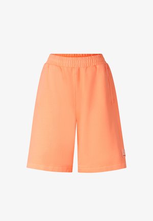 Bright orange elastic waist shorts with side pockets and a small logo patch near the bottom hem on the right leg.