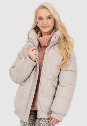 Beige puffer jacket with a high collar, diamond stitching, and snap closures. Features large pockets and ribbed cuffs.