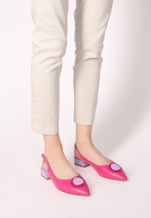 Pink leather slingback shoes with a pointed toe, featuring a circular purple accent and a low, square purple block heel.