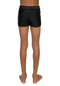 Shorts de bain noirs avec une large taille élastique, portant le texte "PROTEST". Le tissu est lisse et ajusté.