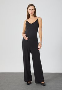 Black jumpsuit with spaghetti straps, V-neckline, and wide-leg design. Made of stretchy material, suitable for maternity wear.