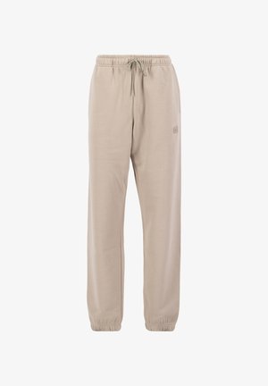 Beige spordipüksid pehmest kangast, millel on nööriga vöökoht, elastsed soonikud ja külgedel väike logo.