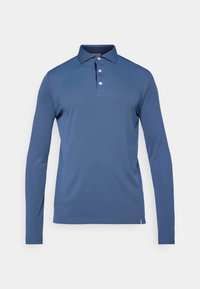 Polo majica z dolgimi rokavi v enotni mornarsko modri barvi. Narejena iz mehke tkanine s klasičnim ovratnikom in plaketko z tremi gumbi. Ima prilagojen kroj.