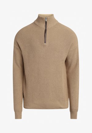 Maglione beige lavorato a maglia con colletto alto e cerniera corta, dotato di polsini e bordo a coste, tessuto strutturato con una vestibilità ampia.