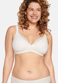 White striped bra with a triangular design, adjustable straps, and soft fabric texture. Seamless cups for a smooth appearance.