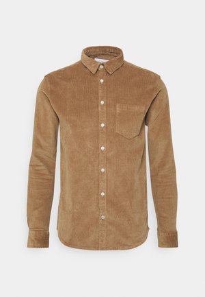 Bruine corduroyshirt met lange mouwen, knoopsluiting aan de voorkant en een enkele borstzak. Voorzien van een klassieke kraag en textuurstof.