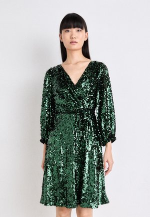 Green sequin dress with a V-neck, long sleeves, and a tie waist, featuring a flared hem and a shiny textured finish.