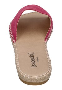 Pink suede slip-on sandal featuring a wide strap, woven detailing along the sole, and a flat, beige rubber outsole.