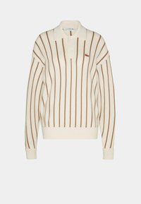 Krémový dlouhý rukáv polo svetr s hnědými vertikálními pruhy, límcovým výstřihem a vyšitým logem na levé straně hrudi. Měkká struktura.