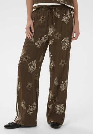 Pruunid laiade säärtega püksid kreemika mere-teemalise mustriga, nööriga vöökohas, külgedel triibud, kantud mustade baleriinikingadega.