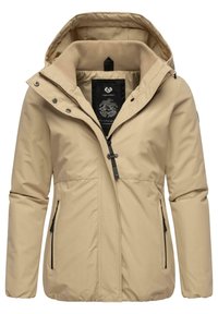 Beige vattenavvisande jacka med huva, med dragkedja framtill, tryckknappar, två sidofickor och ribbad innertäcke.