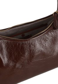 Dark brown glossy leather handbag with top zipper partially open, revealing a gray fabric interior and an inner zippered pocket.
