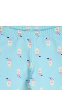 Leggings azzurri chiari con un motivo ripetuto di coppe di gelato in colori pastello con accenti rosa e blu. Realizzati in un tessuto morbido e elasticizzato.