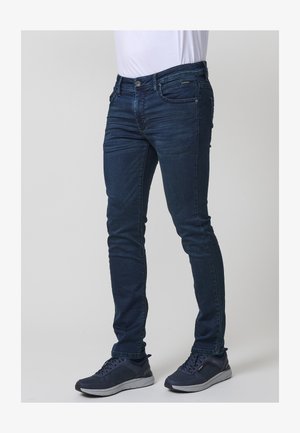Ciemnoniebieskie dopasowane dżinsy wykonane z denimu, charakteryzujące się klasycznym pięciopocketowym wzorem, delikatnym wyblaknięciem oraz zapięciem na zamek błyskawiczny.