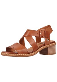 Brown leather sandal with crisscross straps, open toe, and a block heel. Features decorative stitching and a side buckle for adjustment.
