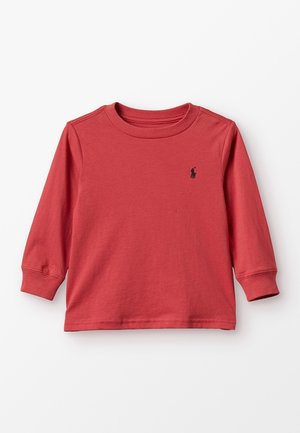 Langærmet rød toddler-trøje med rund hals og lille sort broderet logo på venstre bryst, lagt fladt på hvid baggrund.