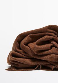 Brown, textured fabric, softly folded with visible fibers, shows a warm, rich hue. Ideal for cozy wear or layering.