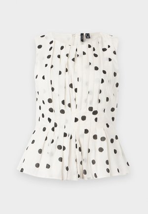 Ärmelloses Oberteil in Weiß mit schwarzen Punkten, mit Falten und einem ausgestellten Saum. Der Stoff wirkt leicht und strukturiert. Mit Reißverschluss auf der Rückseite.