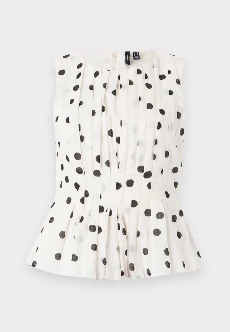 Top sans manches blanc à pois noirs, avec des plis et un ourlet évasé. Le tissu semble léger et texturé. Fermeture à glissière au dos.