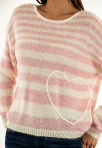 Pull en maille rayé rose pâle et blanc. Présente un détail en forme de cœur à l'avant, un col rond et un ourlet côtelé.