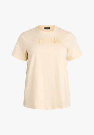 Světlé krémové tričko z bavlny s krátkými rukávy. Na přední straně má strukturovaný nápis "SHINE" v odpovídající barvě.