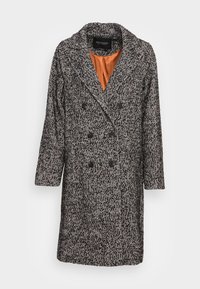 Cappotto doppiopetto con motivo a spina di pesce bianco e nero, realizzato in un misto lana strutturato e foderato internamente con raso arancione a contrasto.