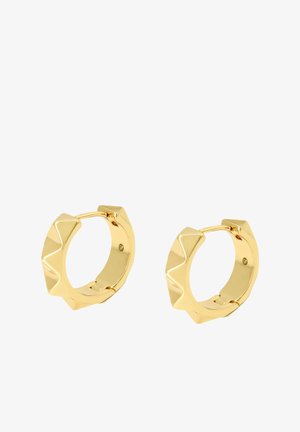 Boucles d'oreilles en or en forme de cercle avec un design géométrique mettant en avant des encoches le long du bord. Texture lisse avec une finition brillante.