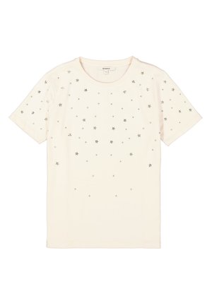 T-shirt crème à manches courtes avec des embellissements en forme d'étoile en argent et de petits strass dispersés sur le devant. Texture de tissu lisse.