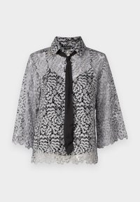 Spitzenbluse in Silber mit einer schwarzen Krawatte. Merkmale sind Glockenärmel, florale Muster und ein spitzes Kragen. Durchsichtige Textur mit einem gewellten Saum.