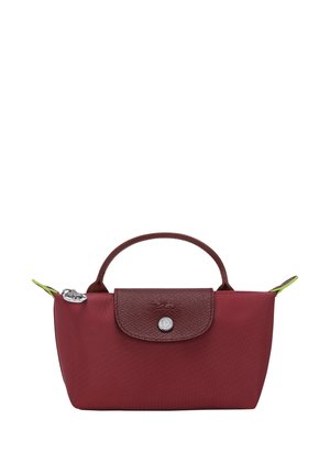 Red nylon bag with a brown leather flap, round handle, and silver snap closure. Features green accents and a textured flap surface.