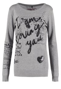 Pull gris à manches longues avec texte noir au style manuscrit et mots en sequins "I dunno loving you" ainsi qu'un petit cœur en sequins sur le devant.