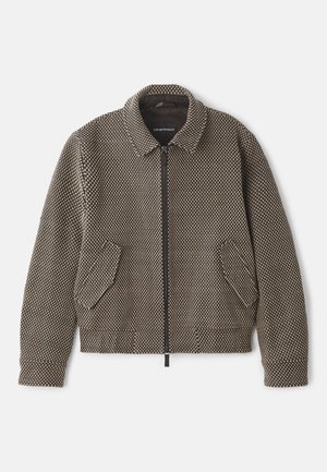 Textured zip-up jacket in brown and beige, featuring a collar, two front pockets, and a polka dot pattern throughout.