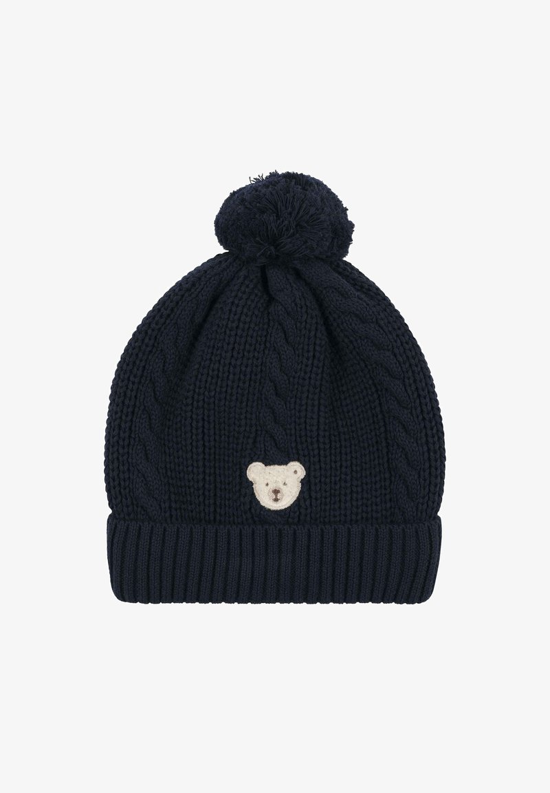 Navy knitted beanie with cable pattern, ribbed brim, and a fluffy pom-pom on top. Features a cream bear face embroidered on the front.