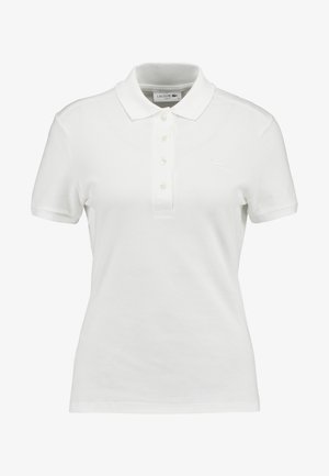 Vit polo t-shirt i texturerad bomull, med klassisk krage, treknappslås och en liten Lacoste-logotyp på bröstet.