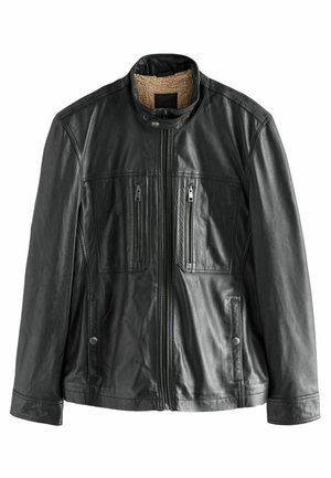 Černá kožená bunda s vysokým límcem, dvěma zipovými kapsami na hrudi a měkkou, béžově podšívkou. Má mírně texturovaný povrch.