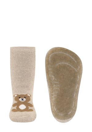 Beige socks with a brown teddy bear design on the front. The sole features a textured grip pattern for added traction.