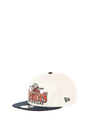 White cap with a navy brim, featuring "Patriots" in red and black lettering, and a football helmet graphic. New Era logo on the side.