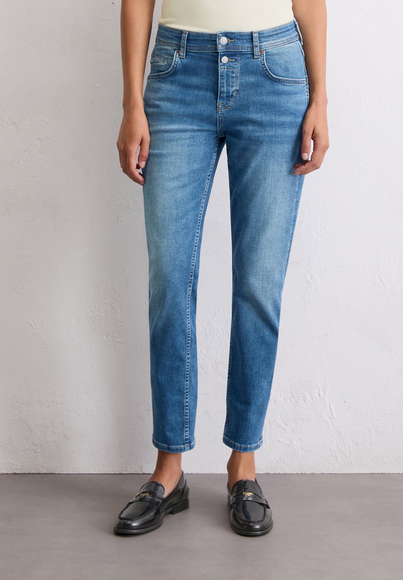 Lichtblauwe denim jeans met een rechte pasvorm, vijf-pocket ontwerp en een sluiting met twee knopen. De stof heeft een gladde textuur en een lichte vervaging.