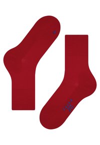 Red crew socks made of knit material. Features a reinforced heel and toe, with “FALKE” and size printed in blue on the side.