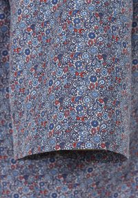 Modrá látka s červenými a světle modrými květinovými a paisley vzory. Hladký povrch, lehká a s propracovanými detaily designu po celé ploše.