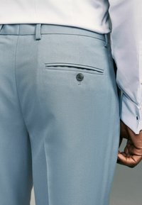 Next Oblekové kalhoty - light blue