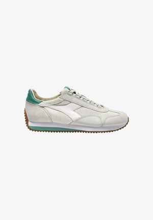 Sneaker bianca con dettagli in teal, superiore in suede e tessuto, suola in gomma e design con lacci. Presenta un logo sul tallone e una silhouette sportiva.