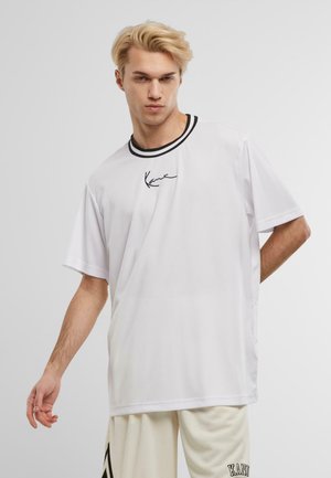 White short-sleeve t-shirt featuring a black ribbed collar and a signature logo in black on the left chest. Minimalist design and relaxed fit.