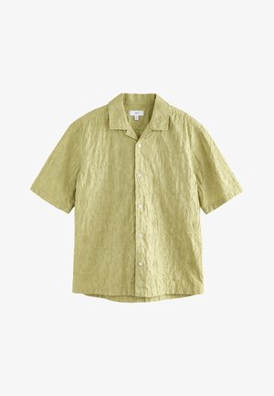 Trumpomis rankovėmis marškiniai šviesiai žali, su iškiliais suktuko raštais, apykakle ir priekiniais mygtukais. Pagaminti iš faktūrinės medžiagos.