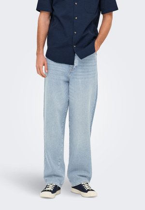 Light blue wide-leg jeans made of denim, paired with a short-sleeve navy textured shirt with a button-up front and one chest pocket.