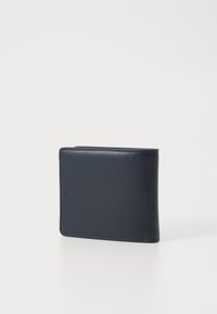 Navy leather wallet with a smooth texture, bi-fold design, rounded edges, and contrasting stitching along the seams. Compact and minimalistic.