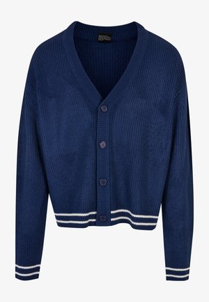 Tengerészkék bordás kardigán V-nyakkal, öt gombbal és fehér csíkos részletekkel a mandzsettákon és az alján. Puha tapintású és testhezálló fazon.